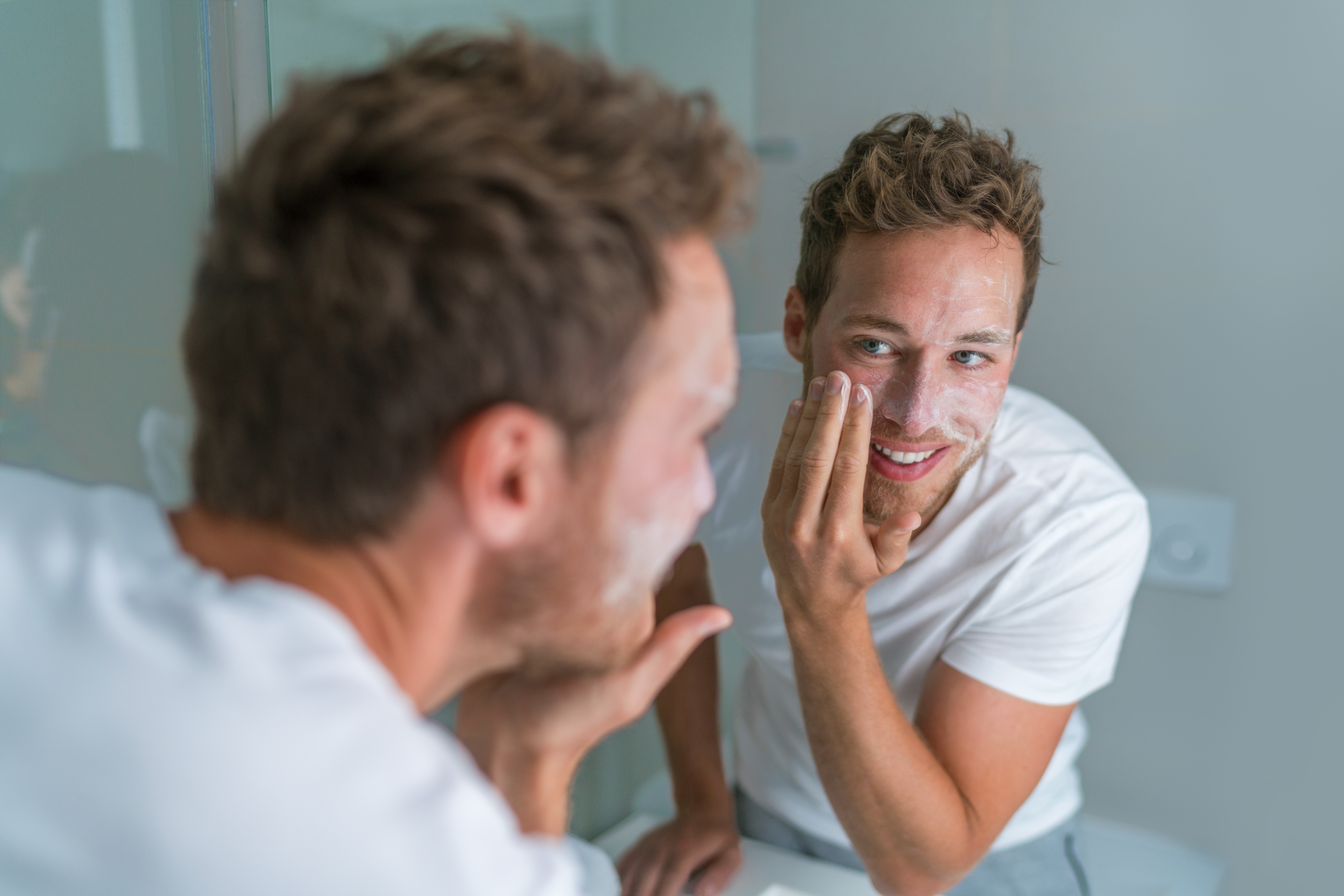 Man using face scrub facial exfoliation