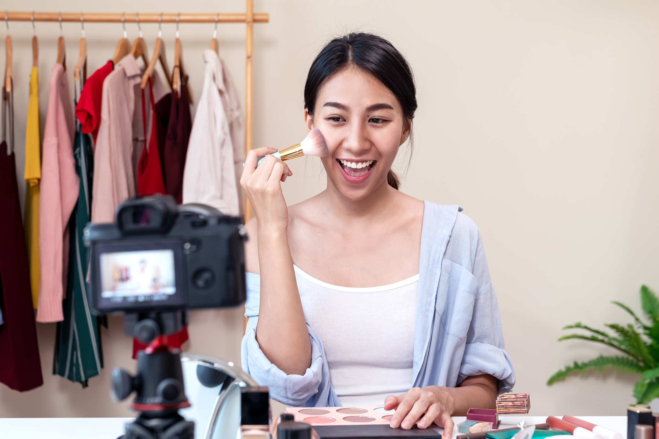 Woman apply make-up demonstration on camera