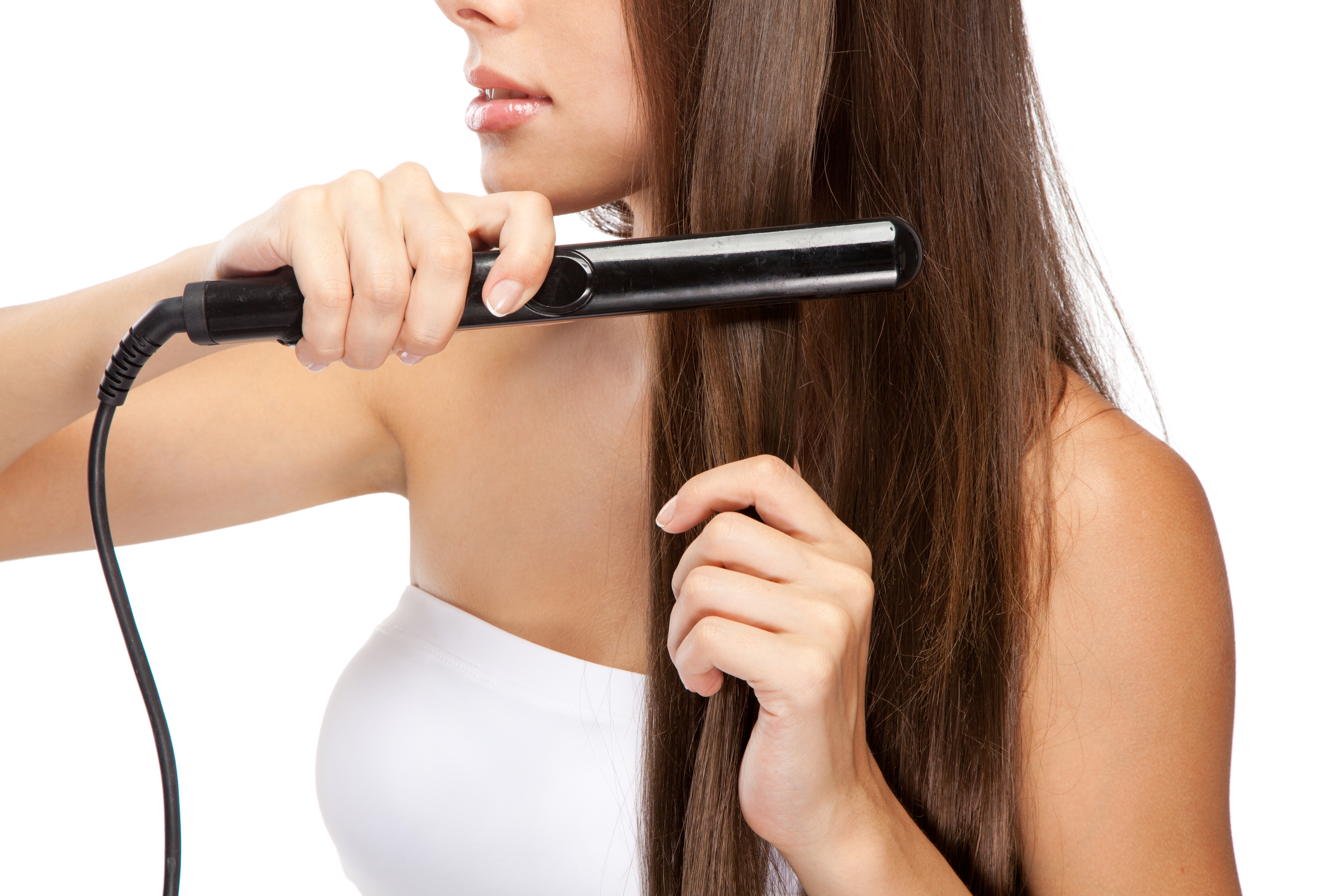 Woman straightening hair