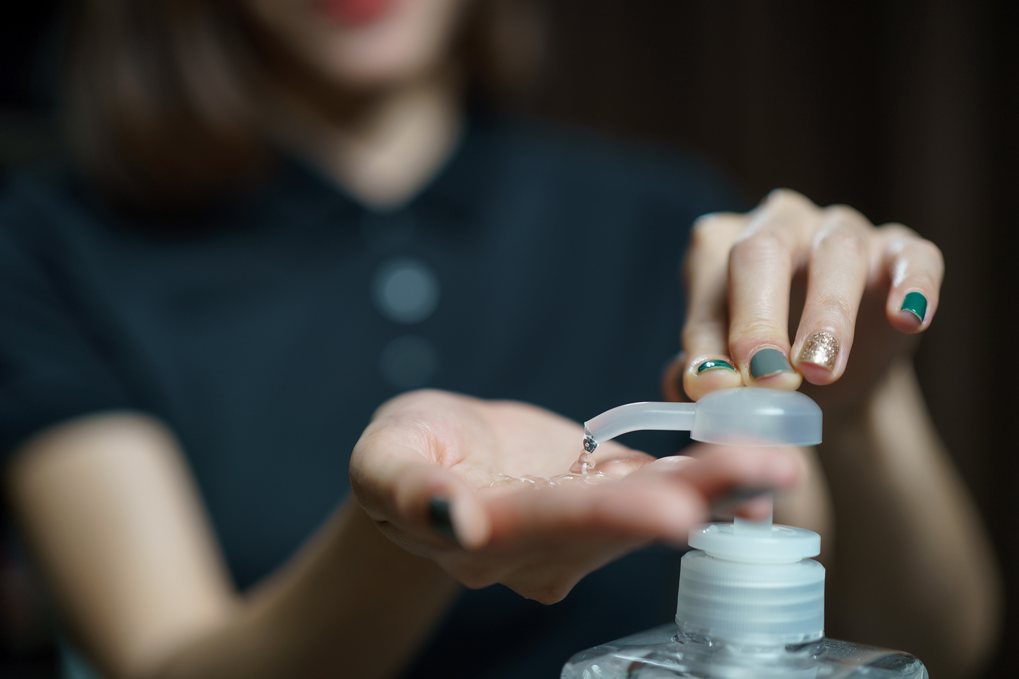 beauty therapist using hand sanitizer