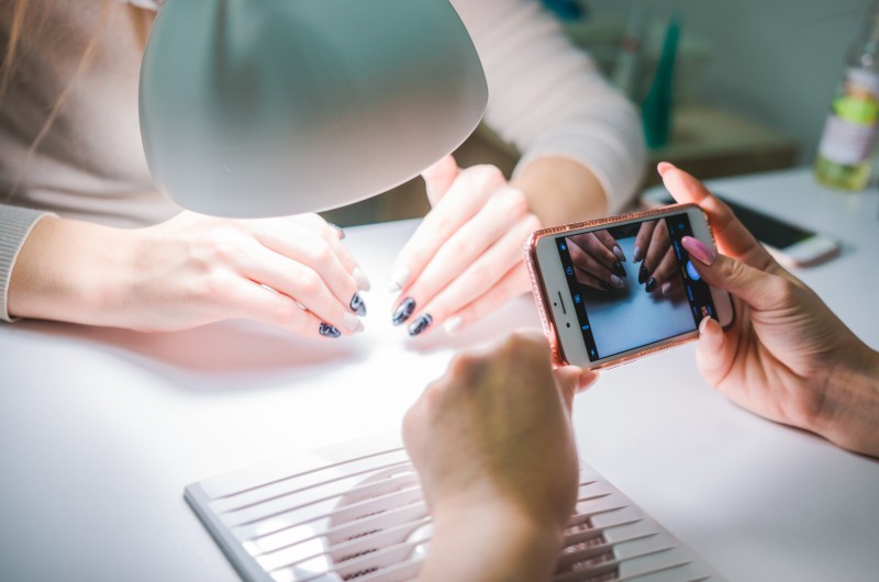 Filming nail manicure treatment.